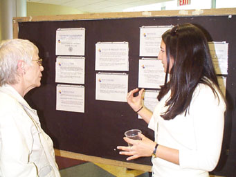 Jessica Cataldo describes her research to Professor  Braginsky