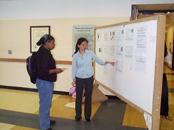 Junior Hein Le presents her project to LaQueta Hudson