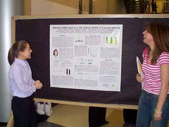 Anne Morris presents to students, and professors Susan Rakowitz and Shannon Harding