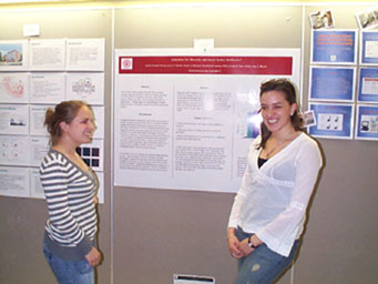 JoAnn Paradis '07 (right) presents her psychology project, education for diversity and social justice, to student