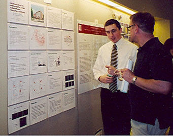 Thomas Johnson '07 converses with Dr. Walker on his biology research project conducted at the Feinstein Institute for Medical Research 